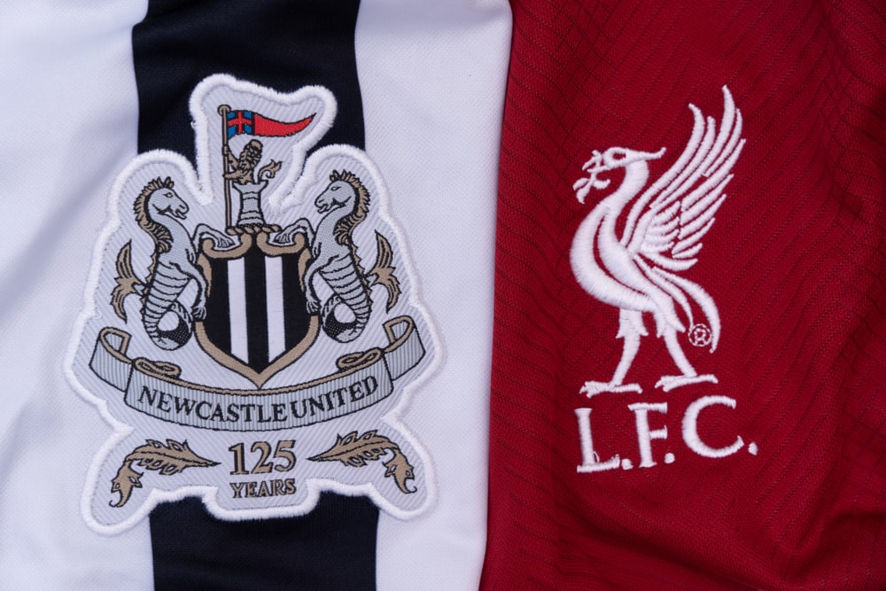 Liverpool and Newcastle United logos on jerseys