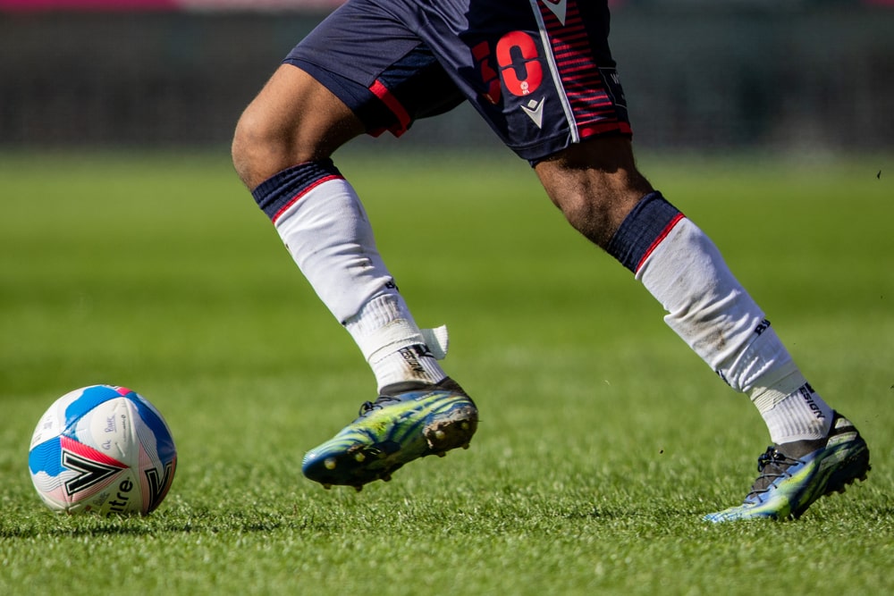 Legs of football player with EFL ball